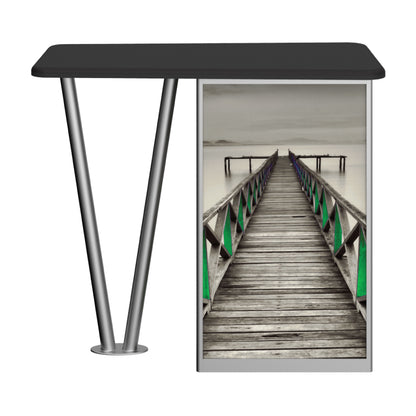 Trade show counter with metal legs and graphic panel featuring a long wooden pier leading into calm water