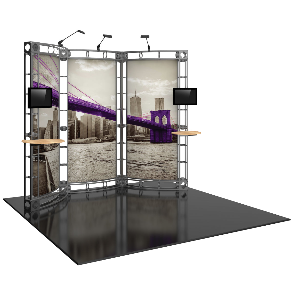 Modular trade show display with large graphic panels, mounted screens, shelving, and overhead lights