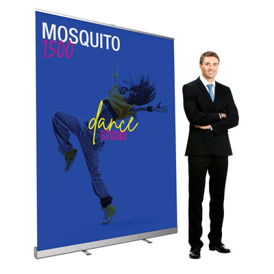 Retractable banner stand with dance studio graphic displayed next to a man in business suit for trade shows