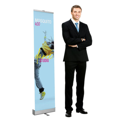 Retractable banner stand displaying dance studio advertisement with man in business suit for trade shows