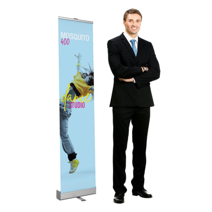 Retractable banner stand displaying dance studio advertisement with man in business suit for trade shows