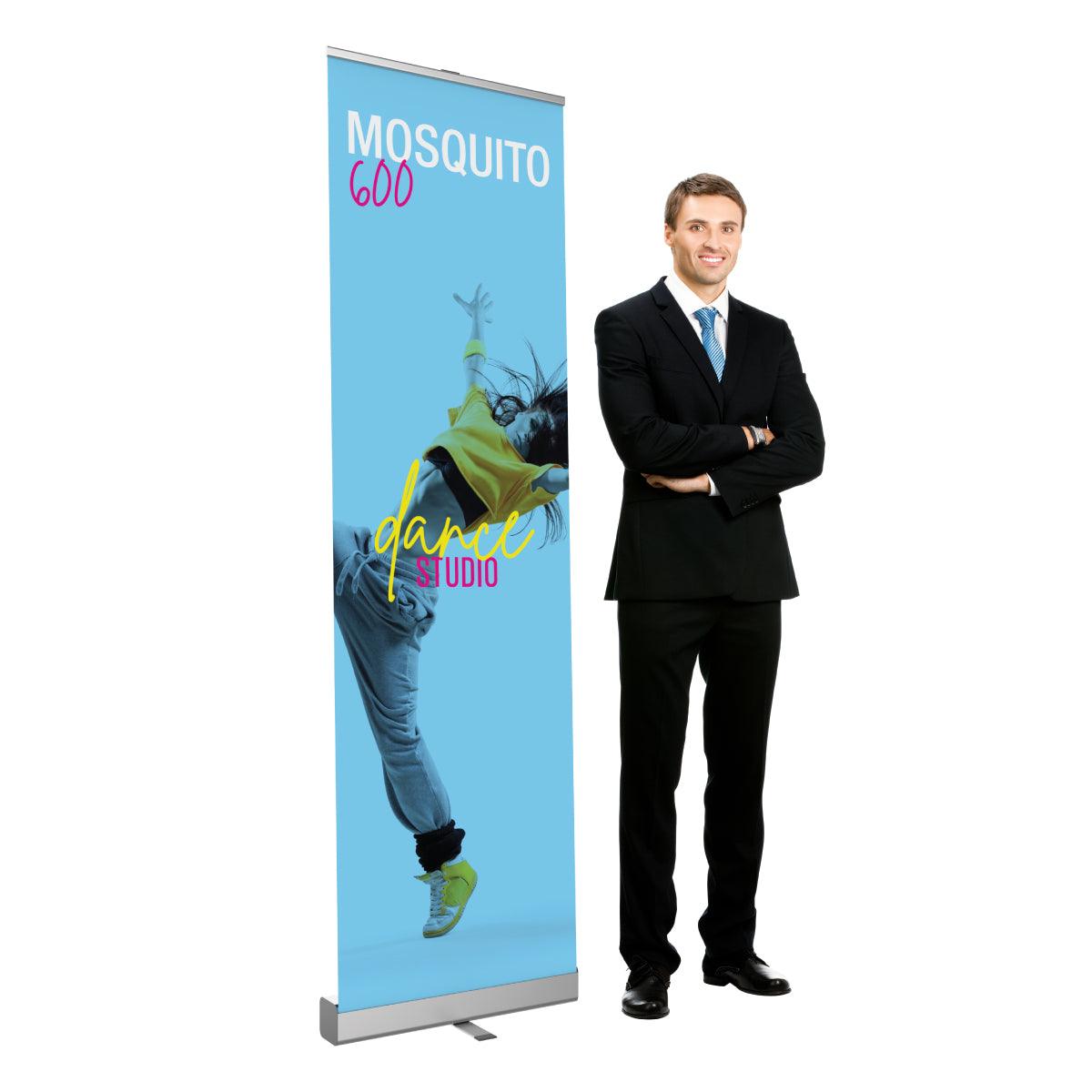 Retractable banner stand featuring dance studio promo next to man in business suit for trade show display