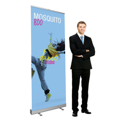 Retractable banner stand with dance studio print displayed next to businessman, ideal for trade shows and exhibitions
