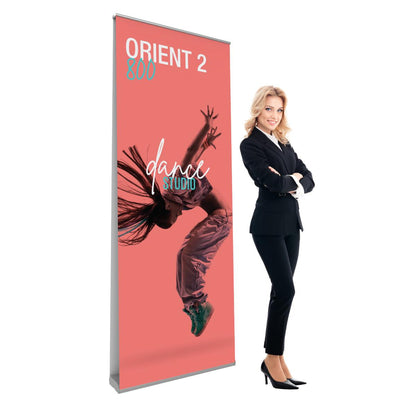 Double-sided banner stand with dance studio graphic beside smiling businesswoman in suit for trade shows and exhibitions