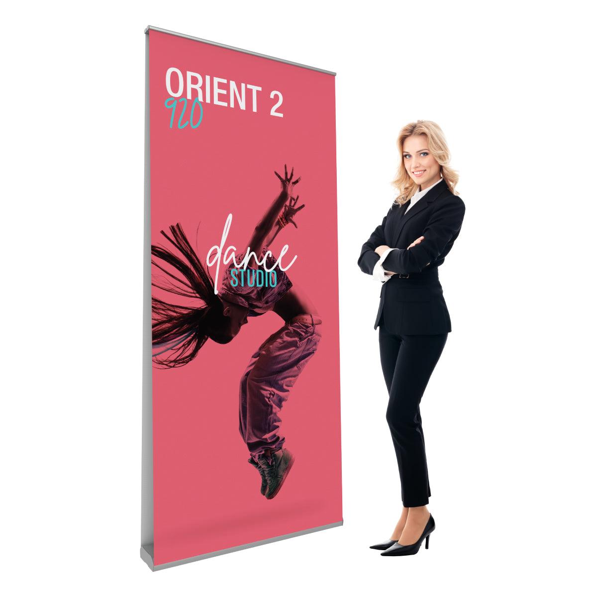 Double-sided banner stand displaying dance studio design with a woman in business attire, suitable for trade shows and events