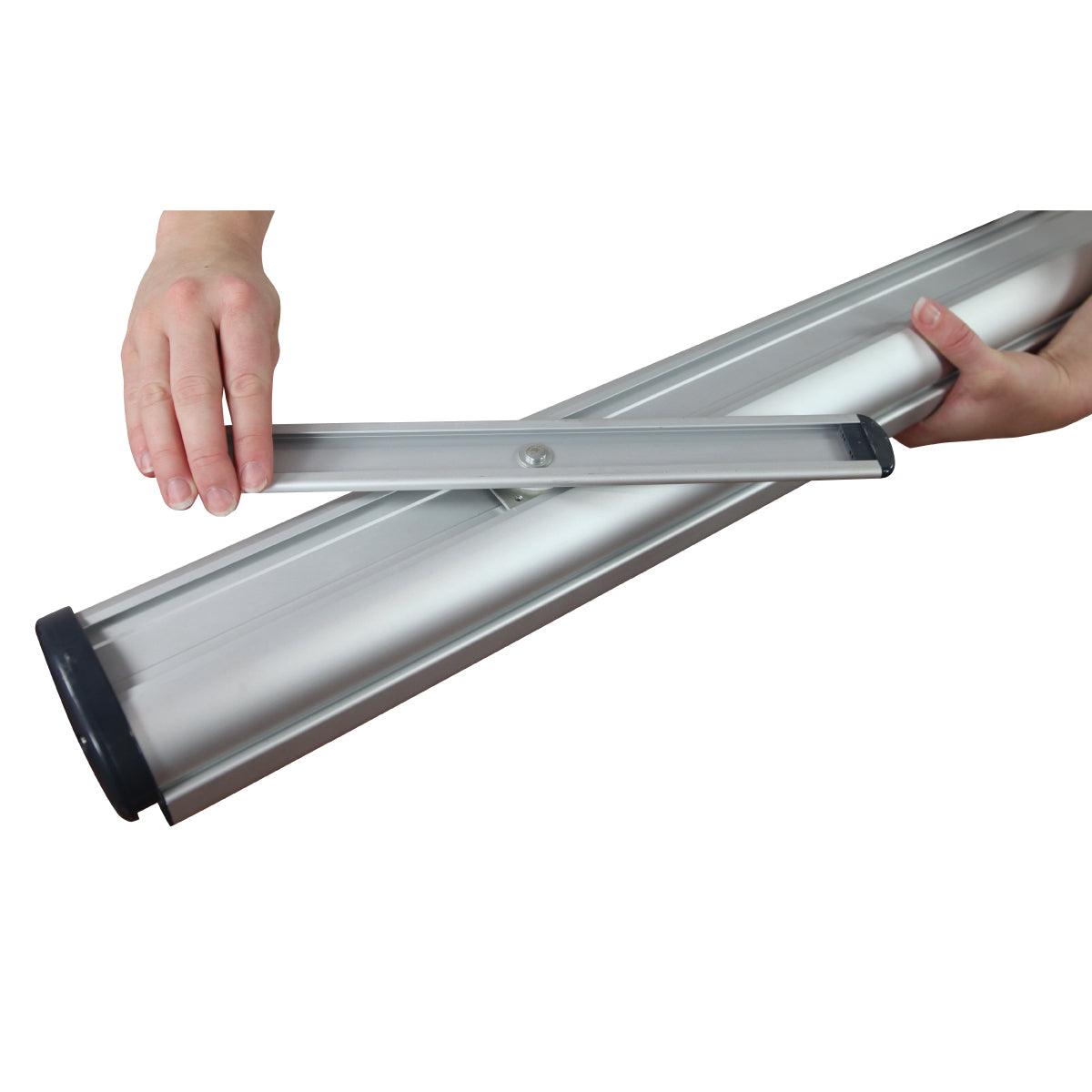 Hands assembling a retractable banner stand base for trade shows and exhibitions