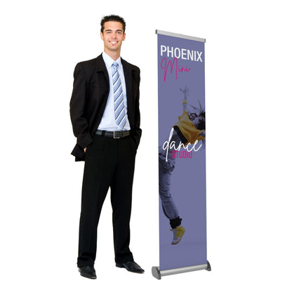 Man in business attire standing next to a portable Phoenix Mini banner stand for trade shows and exhibitions
