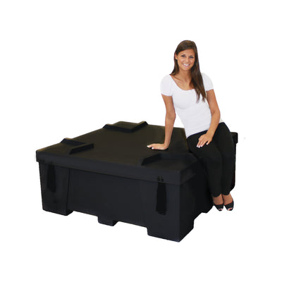 Portable modular display case with a woman sitting on it, ideal for trade shows and exhibitions