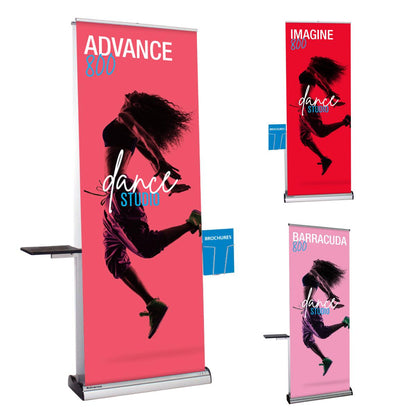 Three retractable banner stands with dance studio advertisements, brochure holders, and side tables for trade shows