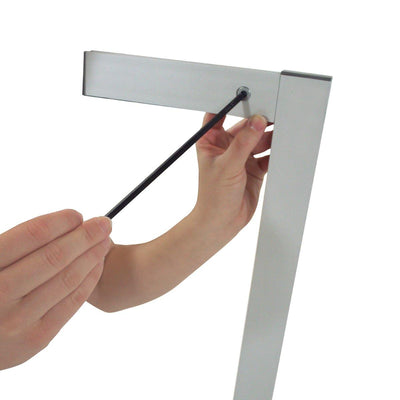 Hands assembling banner stand frame accessory kit for trade shows and exhibitions