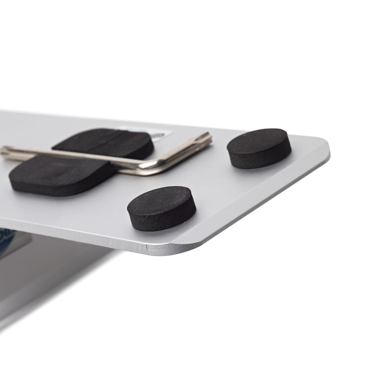 Close-up of a rigid sign panel base with protective black foam pads and an Allen wrench, used for trade shows and exhibitions