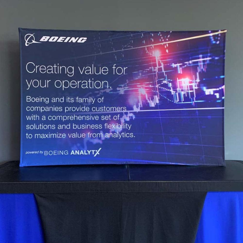 Trade show tabletop display with Boeing branding promoting analytics solutions for business operations