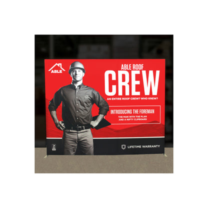 Trade show backdrop featuring a foreman with clipboard for roofing crew promotion and lifetime warranty