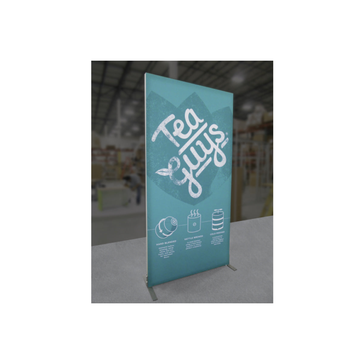 Freestanding trade show banner display with Tea Guys logo and product brewing process illustrations