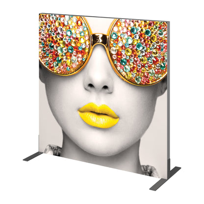 Trade show fabric display featuring close-up of woman's face with embellished sunglasses and prominent lips
