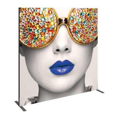 Large graphic display featuring close-up of face with embellished sunglasses and bold lips for trade shows