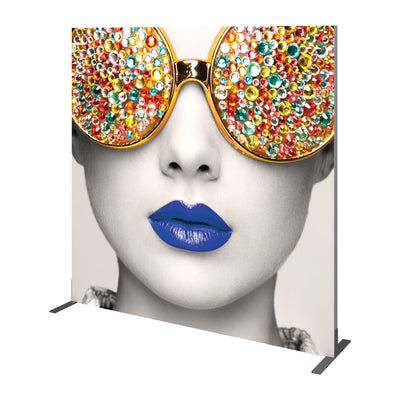 Large trade show backdrop featuring a close-up black-and-white face with embellished oversized sunglasses and vibrant lips