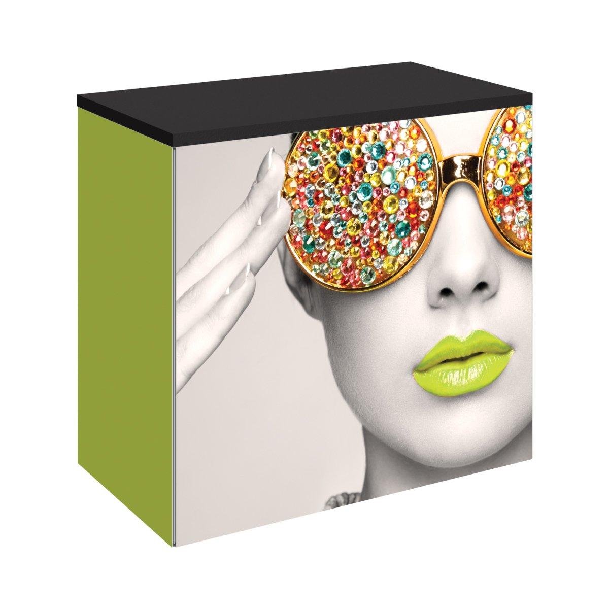 Trade show counter with bold graphic print featuring a woman's face wearing jewel-studded sunglasses