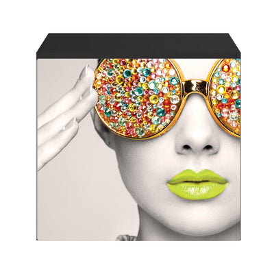 Close-up of promotional trade show counter with artistic print of woman wearing embellished sunglasses and bright lips