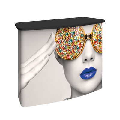 Promotional trade show counter featuring artistic black and white portrait with embellished sunglasses graphic