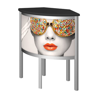 Curved promotional counter with vibrant printed graphic of woman wearing jewel-covered sunglasses for trade shows