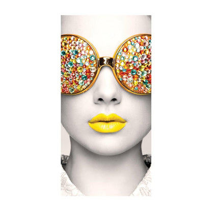 Trade show display featuring close-up artwork of a face with embellished sunglasses and brightly colored lips