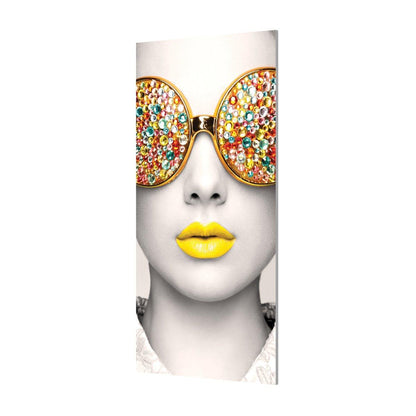Exhibition wall display featuring a close-up black and white portrait with embellished sunglasses and colored lips