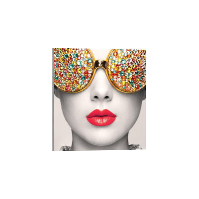 Close-up art display featuring a stylized face with gem-studded sunglasses, ideal for trade show exhibits