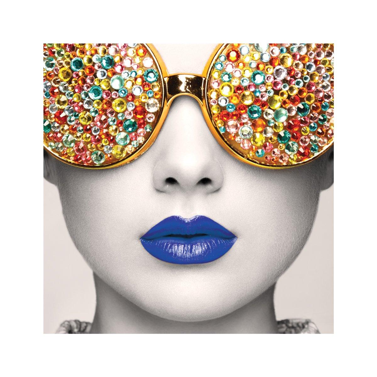 Artistic trade show display featuring close-up face with embellished eyewear and bold lips