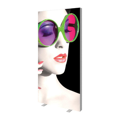 Tall rectangular trade show display featuring close-up image of a woman wearing oversized round sunglasses