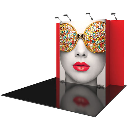 Trade show display booth with large graphic of woman's face wearing embellished sunglasses and spotlight lighting