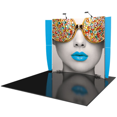 Trade show pop-up display with oversized graphic of a woman's face wearing decorated sunglasses and vibrant lips
