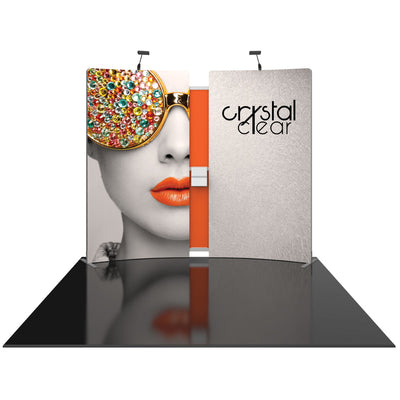 Exhibition trade show display with curved graphic panels featuring artistic portrait and logo, illuminated by overhead lights