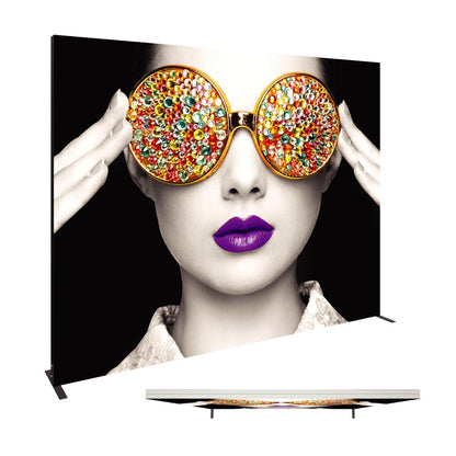 Large trade show fabric display featuring a close-up black and white portrait with colorful gemstone sunglasses and vibrant lips