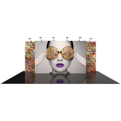 Trade show exhibit with large graphic panels featuring a woman wearing bejeweled glasses and vibrant lips