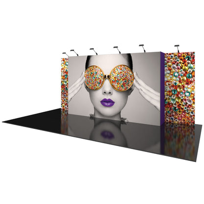 Trade show display with large panel featuring woman wearing sunglasses with colorful gems, side panels with gem patterns