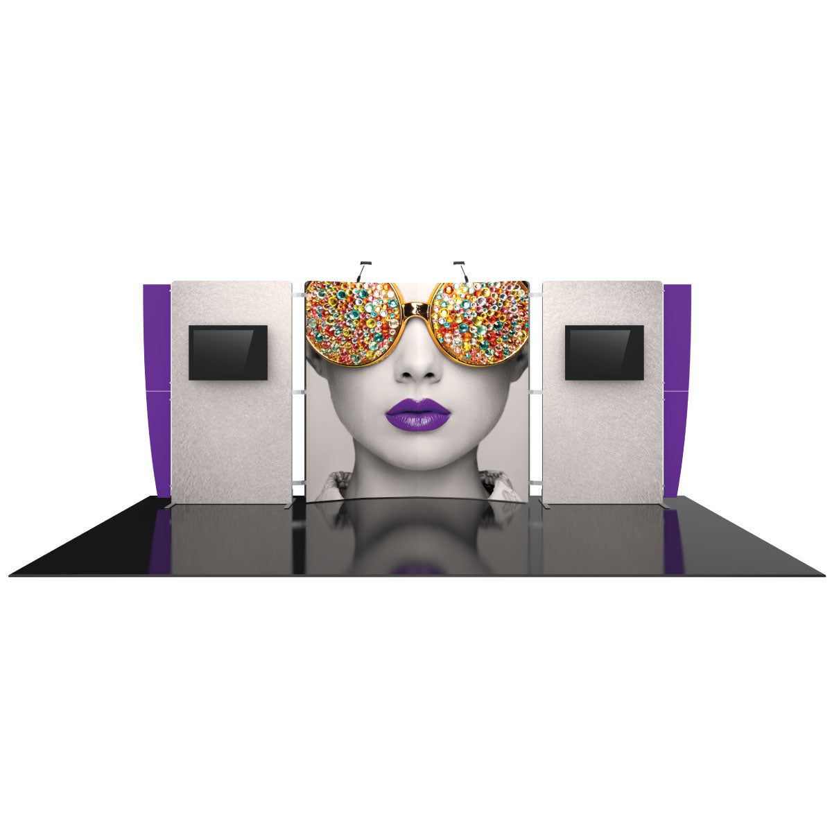 Trade show booth with large graphic panel featuring a woman's face with jeweled sunglasses and purple lips, flanked by display monitors and lighting