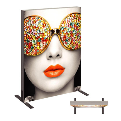 Trade show fabric display featuring close-up portrait with decorative embellished sunglasses and bold lips