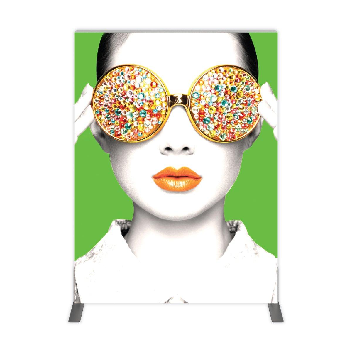 Large trade show backdrop featuring a stylized portrait with embellished sunglasses and vibrant lips