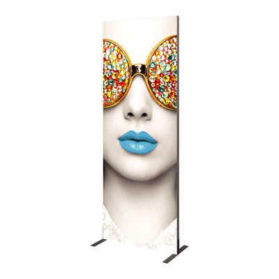 Tall trade show graphic panel featuring close-up image of a woman's face with decorative round glasses and bold lips