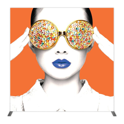Trade show backdrop featuring a stylized portrait of a woman with embellished eyewear and bold lipstick for exhibitions
