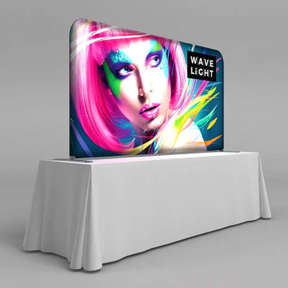 Backlit tabletop display featuring vibrant graphic for trade shows and exhibitions on a covered table