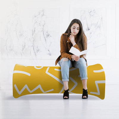 Young woman reading while sitting on modern curved bench in minimalist gallery setting, ideal for trade shows and events