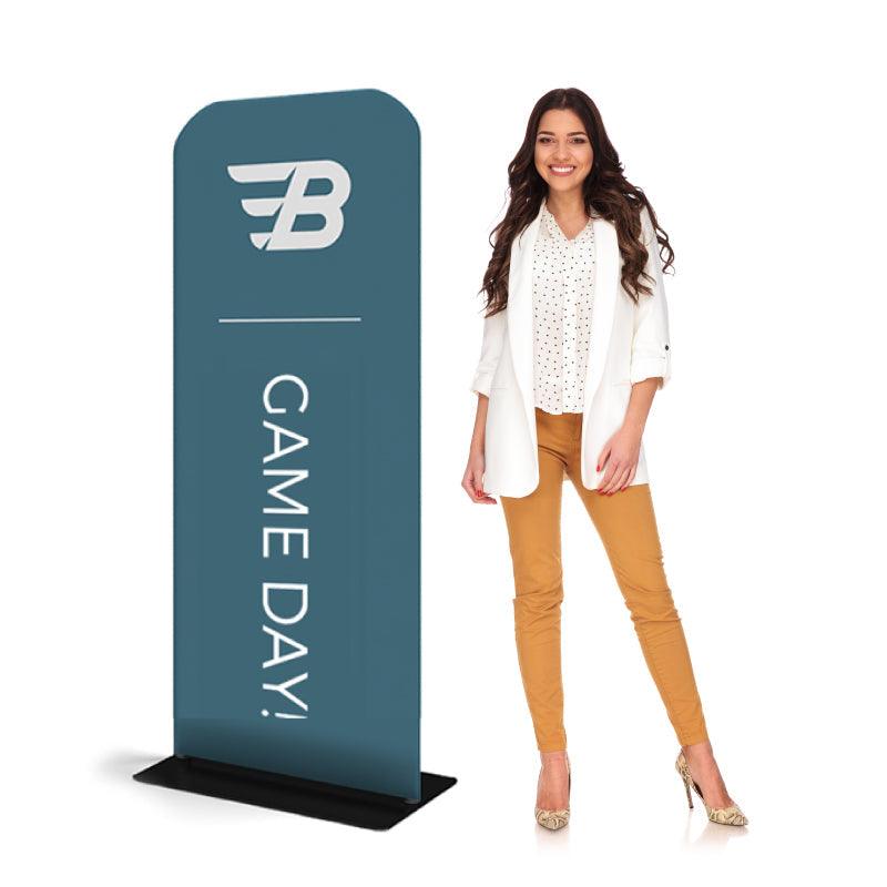 Standing banner display for trade shows and exhibitions with game day promotional text next to smiling woman