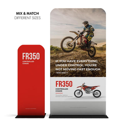 Trade show banner stands featuring motocross bike graphics and promotional text for exhibitions and events
