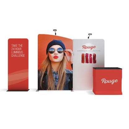 Trade show display with promotional banners and counter featuring fashion and cosmetic branding