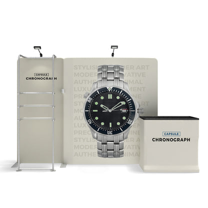 Trade show display featuring a watch advertisement with backdrop, shelving, and branded counter