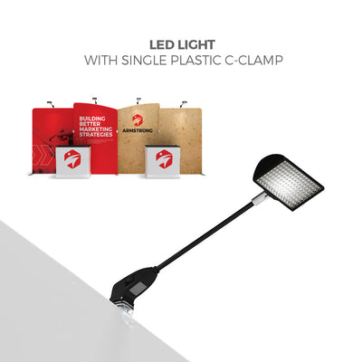 LED light with single plastic C-clamp highlighting trade show display panels and booths