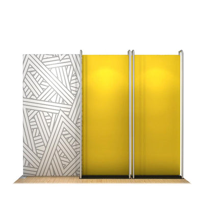 Compact trade show display kit with patterned backdrop and spotlighted panel stands for exhibitions