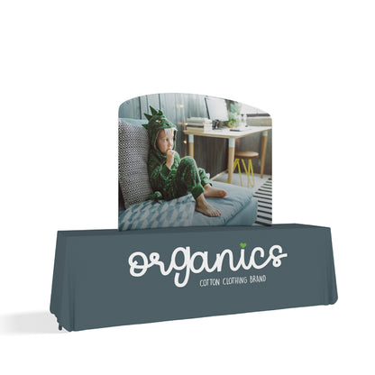 Curved tabletop display and branded table cover for trade shows showcasing children's clothing brand